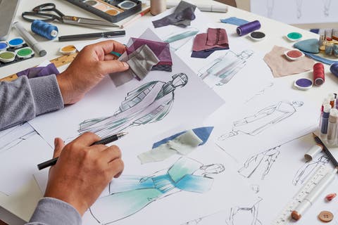 Fashion designer stylish drawings sketches textile fabric material Costume. Designer creative workshop studio.